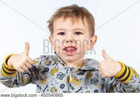 Cute Little Caucasian Boy Shows Myofunctional Trainer.