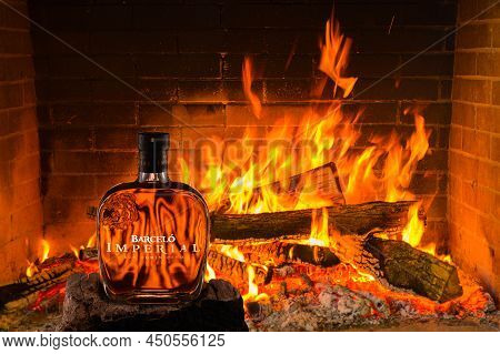 Puerto Plata, Dominican Republic, 2.02.2022. Ron Dominicano Barcelo In Bottle Against Pattern Of Fir