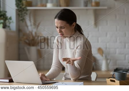 Young Woman Having Problems With Laptop Usage Feels Irritated