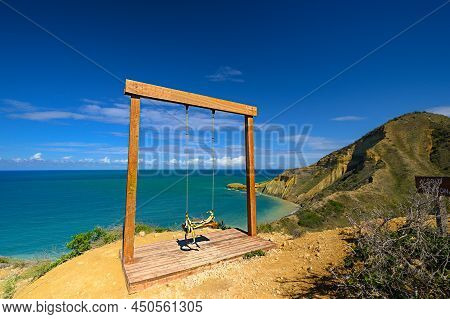 Ocean Swing, Perfect Lagoon. Copy Space. Ocean Swing With Blue Sky Background. Beach Seesaw Without 