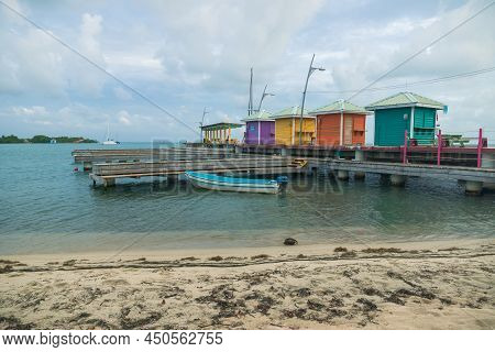 Colorful Wooden Pier Atf The Harbor Of Placencia, Belize