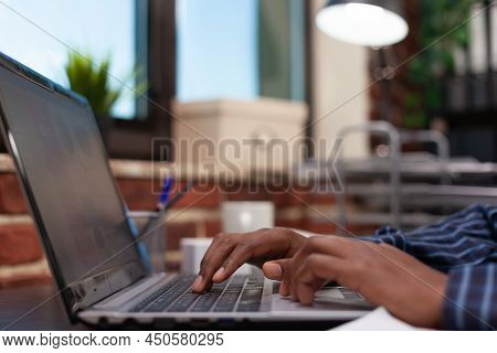 Focus On Startup Employee Hands Typing Business Data On Laptop Keyboard On Small Business Desk. Clos