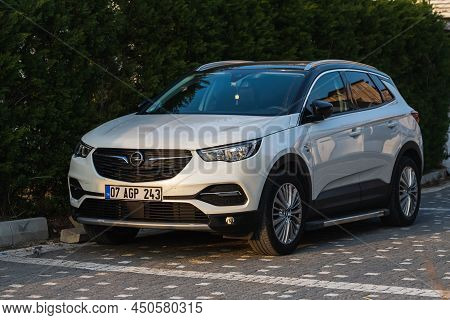 Side, Turkey -february  18, 2022:   White Opel Grandland X  Is Parking  On The Street On A  Summer D