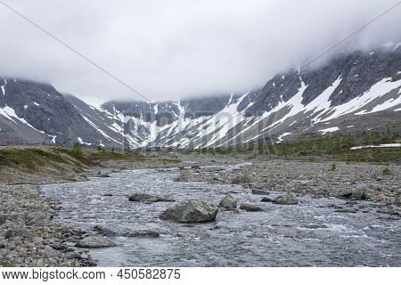 View Of The Hiking Area Near The Lake Blavatnet, Rocks, River, Mountains And Clouds, Lyngen Alps, No