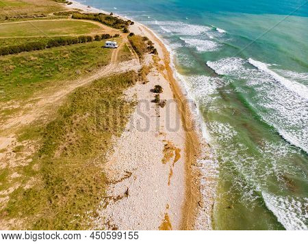 Aerial View. Coastal Landscape With Caravan Wild Camping On Beach Sea Shore. Mediterranean Coast Of 