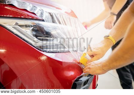Closeup Paint Protection Ppf Is Vinyl Film, Master Installation On Hood Modern Luxury Car
