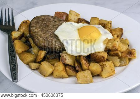 Breakfast Plate With Fried Fried Eggs Sausage,patty On Home Fries