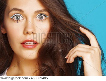 Young Pretty Adorable Brunette Woman With Curly Hair Closeup Like Doll Makeup On Blue Background, Po