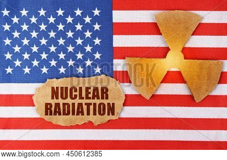Industry And Radiation Concept. On The Flag Of The United States, There Is A Symbol Of Radioactivity
