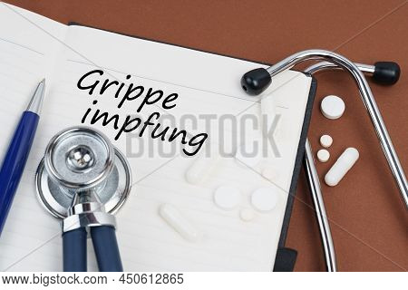 Medicine And Health Concept. On A Brown Surface Lie Pills, A Pen, A Stethoscope And A Notebook With 