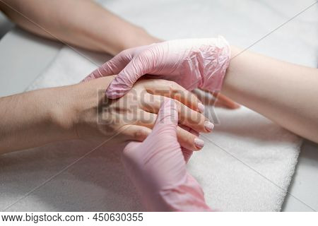 Close-up Hands Beautician, Womans Hands Receive Manicure Treatment, Master Makes A Hand Massage In A