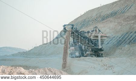 Earth Mover Cleans Up Soil For Road Renewal. Heavy Duty Bulldozer At Work. Quarry Harvester Unit Wit