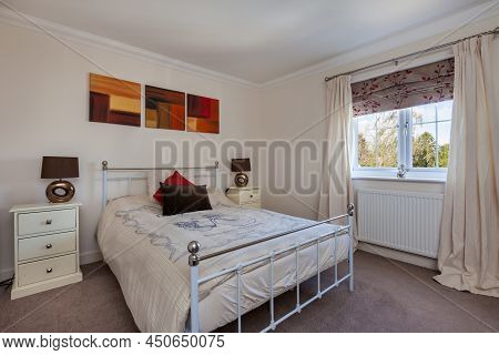 Bottisham, Cambridgeshire - June 4 2015: Modern Furnished Bright Bedroom With Traditional Style Iron