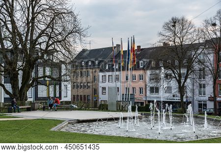 Bitburg, Rhineland-palatinate - Germany -04 08 201: Old Market Square And Fountain With Two Teenage 