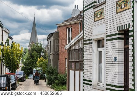 Uccle, Brussels - Belgium - 06 14 2019 - Man With A Bicycle Driving Up The Curling Saint Job Street 