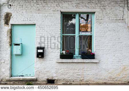 Uccle, Brussels - Belgium - 06 14 2019 - Vintage  Facade Of A Brick Stone Farmers House With A Green