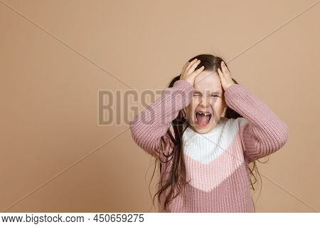 Portrait Of Young Furious Girl With Long Dark Hair In Pink, White Sweater Standing With Open Mouth, 