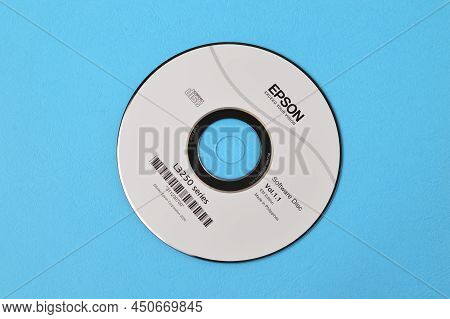 Klang, Malaysia: March 7, 2022- Epson Printer Cd Driver Isolated On A Blue Background