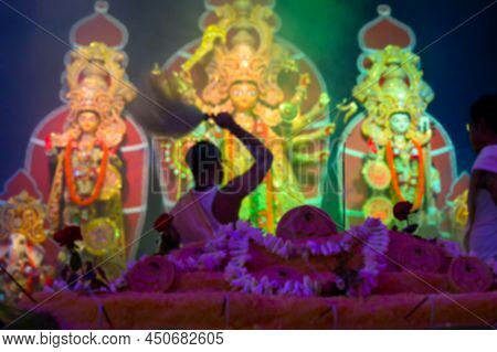 Blurred Image Of Goddess Durga Is Being Worshipped By Hindu Priest With Chamor. Vog, The Holy Food I