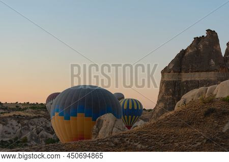 Hot Air Balloons Rising Into The Sky During Sunrise. Travel Concept.