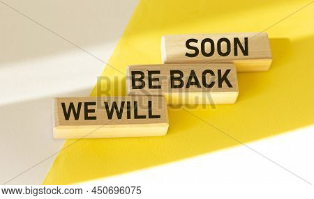 We'll Be Back Soon, Text On Wooden Blocks And White And Yellow Background