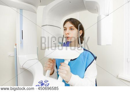 A Girl Makes A Panoramic Rengen. Health Care Concept. Vertical Photo.
