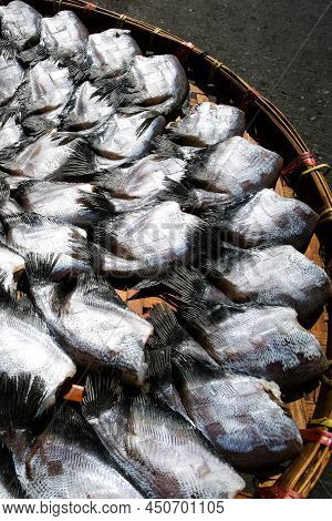 Salted Gourami Fish Lay On Basket In The Sun For Natural Drying. Top View. Flat Lay. Close-up. Selec