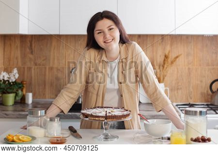 Teen Girl Cooking Nuts Pie In Kitchen