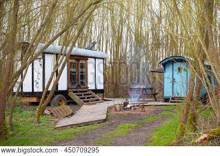 Camping In A Wood With Converted Train Carriages In Gloucestershire, England