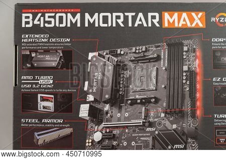 Msi B450 Mortal Max Motherboard Against A Gray Background. Black Box With The New Computer Hardware.