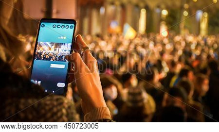 Tbilisi, Georgia - 1st March, 2022: Person Type On Touch Screen On Smartphone To Post News Feed Upda