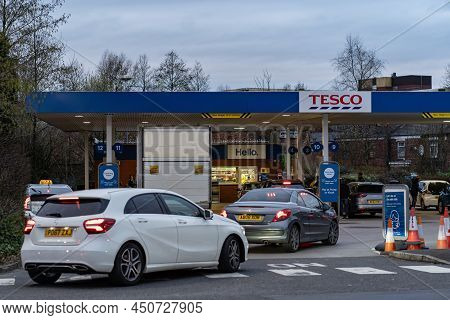 Wigan, Uk: March 10, 2022: Queuing Cars Waiting To Buy Fuel At A Tesco Petrol Filling Station As Bri