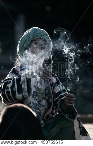 Chiang Mai, Thailand - December 21, 2010: An Elder Lahu Tribe Woman In Traditional Clothing Smoking 