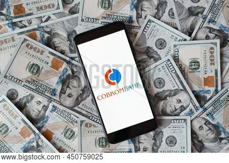 Sovcombank Logo Of Financial Russian Company On Smartphone Screen And Money Background, Top View. Cl