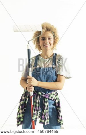Happy Funny Girl Posing With The Paint Roller And Dungarees - Isolated On White Copy Space. High Qua