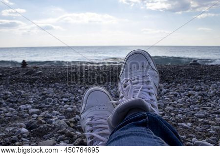 Sneakers On The Background Of The Sea In Southern Italy. Vacation And Vacation Concept.\nwalk Along 