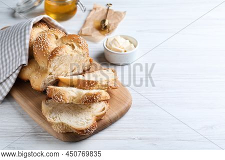 Cut Freshly Baked Braided Bread And Butter On White Wooden Table, Space For Text. Traditional Shabba