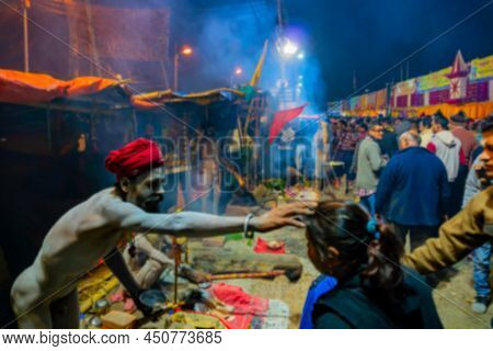 Blurred Image Of Kolkata, West Bengal, India. Hindu Sadhu Blessing Devotees At Gangasagar Transit Ca