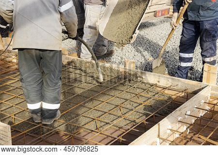 Pouring Cement Or Concrete With A Concrete Mixer Truck, Construction Site With A Reinforced Grillage