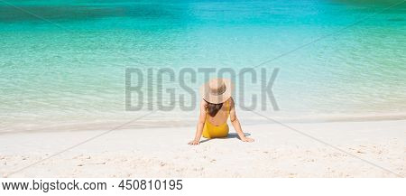Woman Tourist In Yellow Swimsuit And Hat, Happy Traveller Sunbathing At Maya Bay Beach On Phi Phi Is