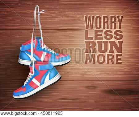 Pair Of Sports Shoes Hanging On Nail In Wood Background With Description Worry Less Run More Realist