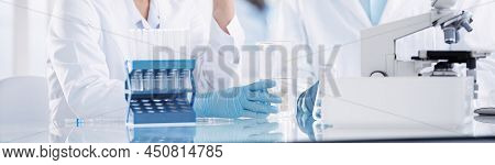 Happy Employees Of The Scientific Laboratory Sitting At The Labo