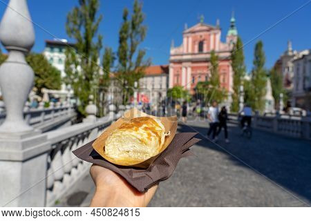 Eating Traditional Slovenian Strukelj Roll In Ljubljana