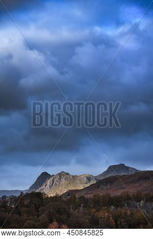 Epic Landscape Image Of Stunning Autumn Sunset Light Across Langdale Pikes Looking From Holme Fell I