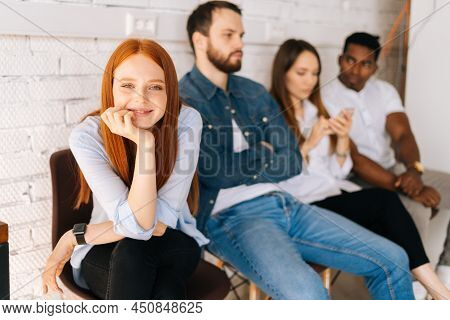 Portrait Of Young Female Job Candidates Smiling Looking At Camera While Waiting Interview With Hr Si
