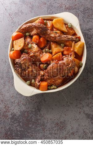 Traditional Malta National Dish Stewed Rabbit Stuffat Tal-fenek Closeup In The Pan On The Table. Ver