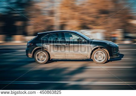 Woman Is Driving Porsche Macan Fast On The Road. Macan Is Luxury Suv Car Made By Famous German Sport
