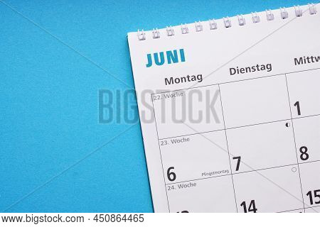 German Calendar Or Planner For The Month Of June On Blue Paper Background With Copy Space