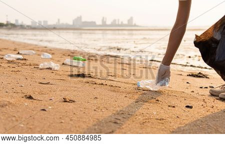 Volunteer Woman Picking Plastic Bottle Into Trash Plastic Bag Black For Cleaning The Beach, Female C