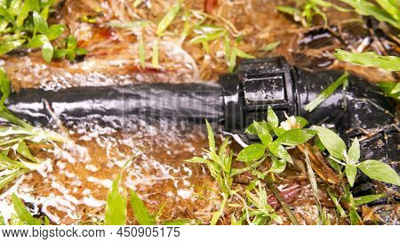 Broken Water Pipe Line . Selective Focus On The Pipe And Water Flowing.